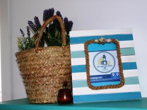 a wicker basket sitting on a table next to a box at B&B Casa del Faro SanVallero Adults Only in Portopalo