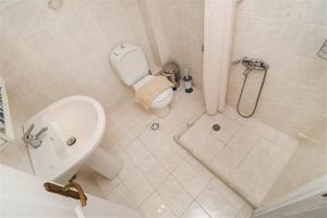 a bathroom with a shower and a toilet and a sink at Victoria House Pefkohori 3 bedrooms 12 guests in Pefkohori +19 photos