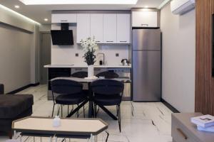 a kitchen and living room with a table and chairs at No25 Suites Nisantasi in Istanbul