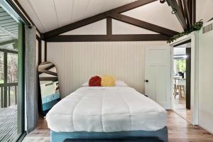 a bedroom with a large white bed in a room at Bear Whispers in Townsend