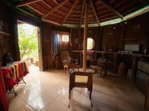 a room with a table and chairs in a house at 1 bedroom cabin, 3 blocks from beach and center of San Juan in San Juan del Sur