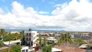 an aerial view of a town with palm trees and buildings at Hotel Sula Sula in Puerto Villamil