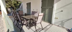 a table and chairs on the balcony of a house at Sissy Villas 1 in Poros