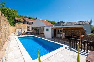 a swimming pool in the backyard of a house at Didovi dvori in Seline