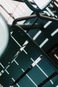 a close up of a metal table with shadows on it at Eleven by Warren Collection in Sliema