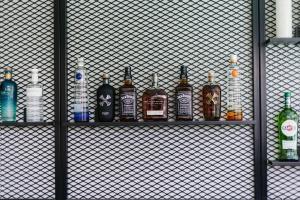 a bunch of bottles sitting on a shelf at Eleven by Warren Collection in Sliema