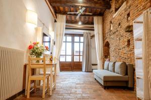 a living room with a couch and a table at Antica Casa Dei Rassicurati in Montecarlo