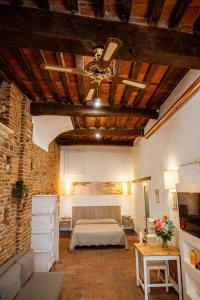 a bedroom with a bed and a brick wall at Antica Casa Dei Rassicurati in Montecarlo