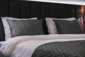 a bed with black and white sheets and pillows at No25 Suites Nisantasi in Istanbul