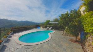 a swimming pool with a view of a mountain at A.R.L.A. House in Cogorno