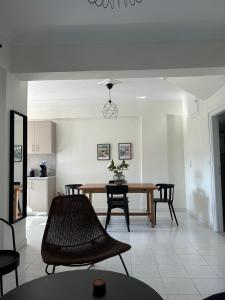 a kitchen and dining room with a table and chairs at Mary Lo Guest House in Nydri