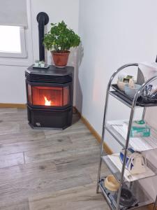 a stove in the corner of a room at La de Fredyy - Tres Marias Apartments in Redondela