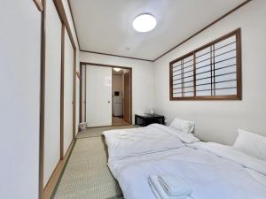 Postel nebo postele na pokoji v ubytování AX-Asaka House + 11 fotografií