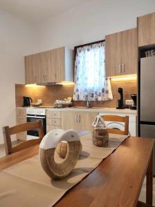 a kitchen with a table with two baskets on it at Villa Andros, Beauty and Luxury - Private Pool in Andros