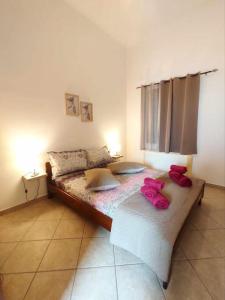 a bedroom with a bed with pink bows on it at Villa Andros, Beauty and Luxury - Private Pool in Andros
