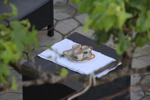 a table with two coffee cups on a napkin at Villa Beni Osmenaj in Vlorë
