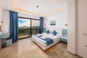a bedroom with a bed and a large window at Villa Albedo Blue in Kaş +66 photos