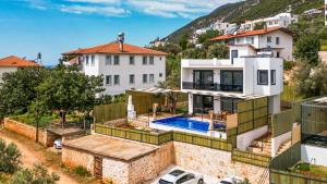 a house with a swimming pool on top of it at Villa Albedo Blue in Kaş