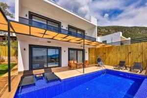 a villa with a swimming pool and a house at Villa Albedo Blue in Kaş