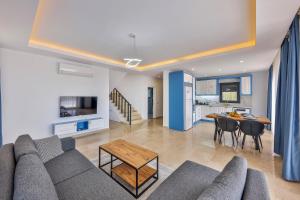 a living room with a couch and a table at Villa Albedo Blue in Kaş