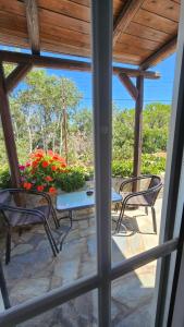a view of a patio with chairs and a table at Enalia Apartments in Korissia