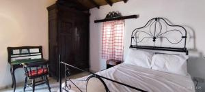 a bedroom with a bed and a chair at Kıbrıs Evi (Cyprus House) in Famagusta
