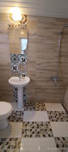 a bathroom with a sink and a toilet and a mirror at Kıbrıs Evi (Cyprus House) in Mağusa