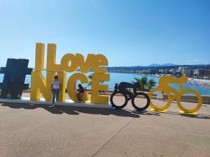 a group of people standing next to a large sign with bikes at Beau studio meublé hyper centre Nice in Nice +1 photo