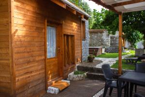 a wooden cabin with a wooden door and a patio at Casa do Ribeirinho in Amarante