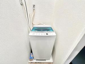 a white toilet sitting on a shelf in a wall at AX-Ojima House in Tokyo
