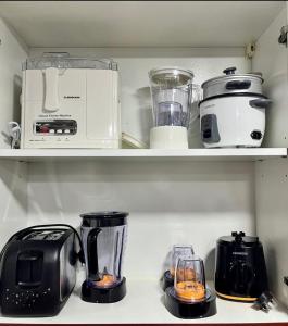 a kitchen shelf with various appliances on it at Stunning 1Bedroom Apartment - With Amazing Dubai Marina View in Dubai