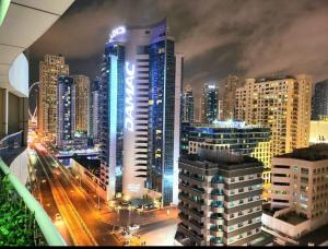 a view of a city at night with buildings at Stunning 1Bedroom Apartment - With Amazing Dubai Marina View in Dubai