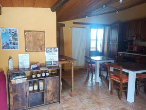 a kitchen with wooden tables and chairs and a table at Rota d'Amont in Stroppo