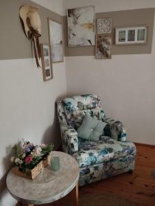 a living room with a chair and a table at OLYMPUS HILL in Litochoro