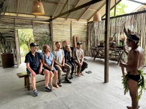 a group of people sitting on a bench in a building at Ponta Poranga Jungle Lodge in Manaus