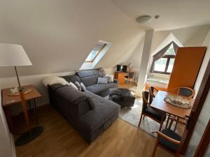 a living room with a couch and a table at Diamant Apartmanház in Eger