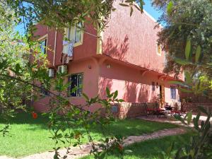 a house with a red roof and some trees at Maison Touria in Ouzoud +23 photos