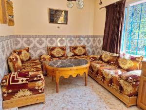 a living room with a couch and a coffee table at Maison Touria in Ouzoud
