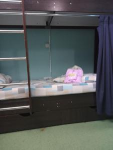 a reflection of a bunk bed with a mirror at Bulgakoff in Kyiv