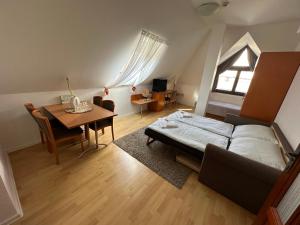 a bedroom with a bed and a table and a dining room at Diamant Apartmanház in Eger