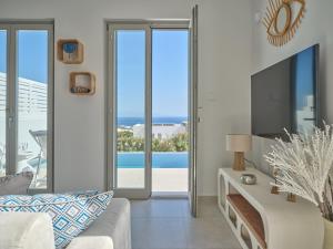 a living room with a view of the ocean at Villa Le22, 180 panoramic sea views, Paros in Kampos Paros