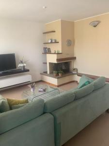 a living room with a couch and a fireplace at Appartamento Gli Ulivi in Mercato Saraceno