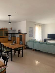 a living room with a couch and a table at Appartamento Gli Ulivi in Mercato Saraceno +30 photos