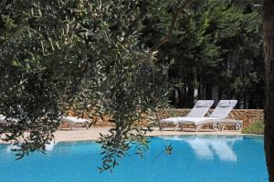 two lounge chairs sitting next to a swimming pool at Maison D'Enrì in Gallipoli