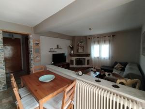 a living room with a couch and a table at OLYMPUS HILL in Litochoro