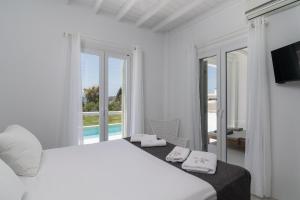 Ένα ή περισσότερα κρεβάτια σε δωμάτιο στο White Villa Milos +25 φωτογραφίες
