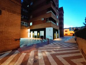 an empty courtyard in front of a building at Ferola Homes in Granada