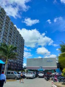 a man walking in front of a parking lot at Haus of Emerald Studio Condo - Saekyung 956 Looc in Cebu City