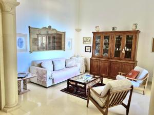 a living room with a couch and a table at Tramonto in Santa Maria al Bagno