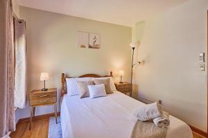 a bedroom with a bed with white sheets and pillows at Spacious Catskills Serenity nearby Delaware River Gap w Game Rm Pet Friendly and Fenced Yard in Glen Spey